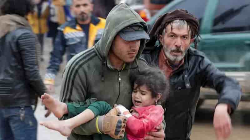 Devastating 7.8 Magnitude Earthquake Strikes Turkey and Syria - More than 2,700 deaths-min Devastating 7.8 Magnitude Earthquake Strikes Turkey and Syria , a man holding a young girl in his arms, with an older man helping him