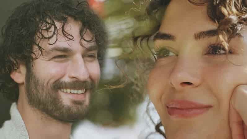 photo of new turkish drama series Yüz Yıllık Mucize featuring a face close up of lead actors Birkan Sokullu and Ebru Şahin, both with curly hair and smiling