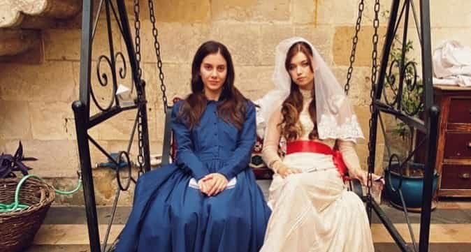 Seyran Suna wearing a blue dress and seyran wearing her wedding dress sitting in their house in Antep before wedding with ferit in the turkish drama series Yalı Çapkını